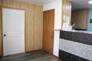 an empty room with a door and a counter at Colonial Inn in Dyersville