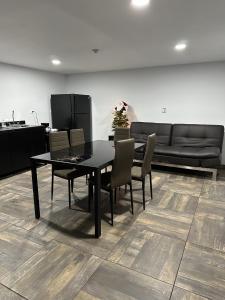 a dining room with a table and chairs and a couch at Hotel y Suites Panda in San Luis Río Colorado
