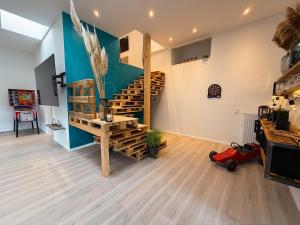 a living room with a wooden spiral staircase in a house at Apartment Jonte im Dangaster Nest in Varel
