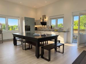 a large kitchen with a table and a dining room at Apartment Jonte im Dangaster Nest in Varel