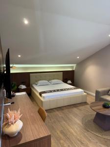 a bedroom with a bed and a living room at NOMA Rooms Murter in Murter