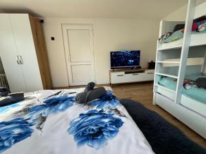 a bedroom with a bed with blue flowers on it at Villa ADUSHI Nashec in Prizren