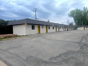 an empty parking lot with a row of buildings at JET Motor Inn - Buffalo in Buffalo