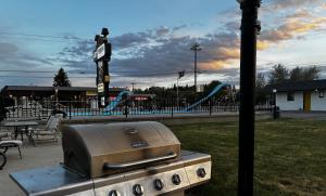 a bbq grill sitting next to a park at JET Motor Inn - Buffalo in Buffalo