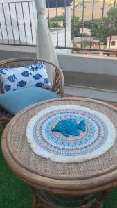 a wicker table with a plate on top of it at Casa Frida in Solanas +3 photos