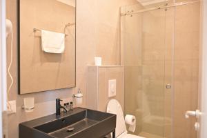 a bathroom with a sink and a shower at MiraMar Hotel in Shëngjin +71 photos