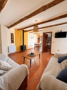 a living room with a couch and a table at Capileira Luz de Sierra in Capileira