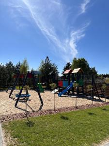 a park with a playground with a slide at Pięć Sosen in Wiele
