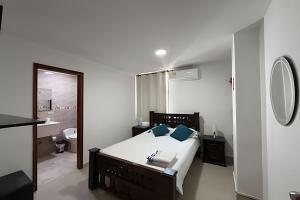 a bedroom with a bed and a bathroom with a mirror at Soberana del Mar by Colproperty Management in Santa Marta +21 photos
