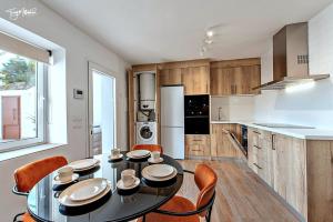 a dining room with a table and chairs in a kitchen at La Cepa Apartamentos in Alhama de Granada +17 photos