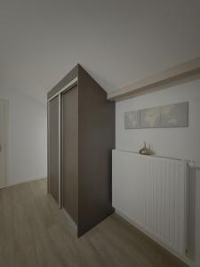 a room with a door and a white wall at Dressing vibe in Ettelbruck