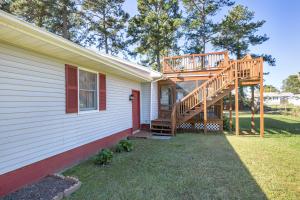 a wooden deck on the side of a house at Happy Pines in Chincoteague