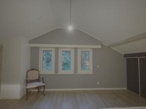 an empty room with a chair and a window at Dressing vibe in Ettelbruck