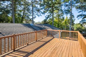 a wooden deck with a roof on top of a house at Happy Pines in Chincoteague +23 photos