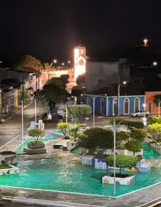 a city street at night with trees and buildings at Pousada Berro do Bode in Cabaceiras