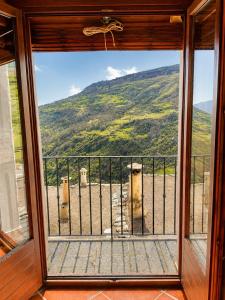 a room with a window with a view of a mountain at Capileira Luz de Sierra in Capileira