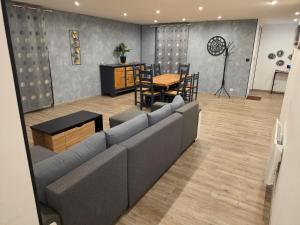 a living room with a couch and a table at maison guy in Priay