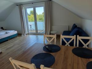 a living room with a table and a couch at u Harrego in Dębki
