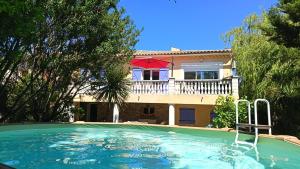 a large swimming pool in front of a house at Maison au calme avec jardin et piscine Saint Raphaël in Saint-Raphaël