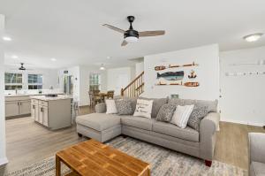 a living room with a couch and a kitchen at Hidden Gem in Greenbackville