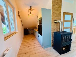 a small kitchen with a stove in a room at Cocon Savoyard - Vues Alpes - 2 king size - Rando & VTT - Parking in Albertville