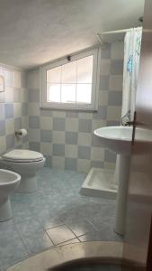 a bathroom with a toilet and a sink at House Mimma Tropea in Santa Domenica +17 photos