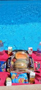 a tray of food sitting next to a swimming pool at Spacious Luxury 5BR Villa with Private Pool near GEM in Kafr Ghaţāţī