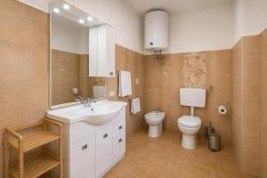 a bathroom with a sink and a toilet at Domo e Mare in Valledoria