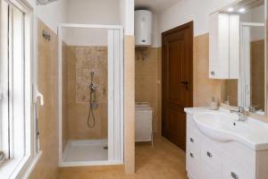 a bathroom with a shower and a sink at Domo e Mare in Valledoria +2 photos