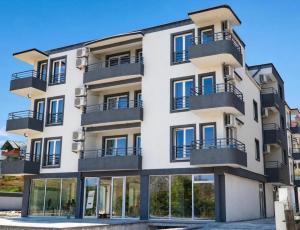an apartment building with balconies and windows at Mia Apartment in Veles