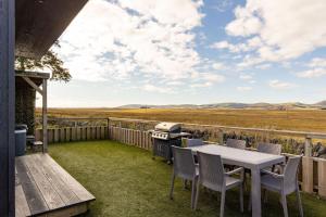 a patio with a table and chairs and a grill at Green Law - Dog Friendly in Penicuik +15 photos