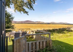 a porch with a fence and a view of a field at Green Law - Dog Friendly in Penicuik