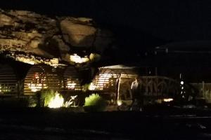 a train car with lights in front of a mountain at مخيم سياحي in Disah
