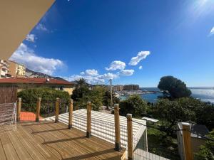 a wooden deck with a view of the ocean at Casa Mediterraneo - Vue mer 3 min de la plage à pieds in Cap d'Ail