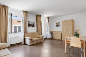 a living room with a couch and a table at Borgo al Mare in Marina di Bibbona