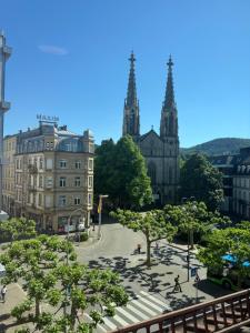 a view of a city with a church and trees at Baden-Baden Zentrum Studio in Baden-Baden