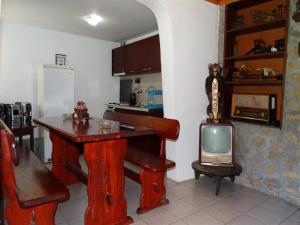a kitchen with a table and a small television at Roden Dom Holiday Home in Apriltsi