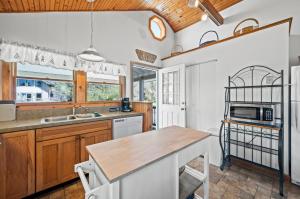 a kitchen with wooden cabinets and a counter top at Les Bon Temps in Birch Town