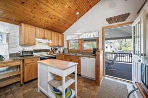a kitchen with wooden cabinets and a balcony at Les Bon Temps in Birch Town