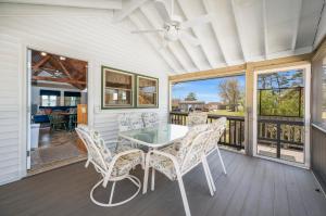 a dining room with a table and chairs on a porch at Les Bon Temps in Birch Town