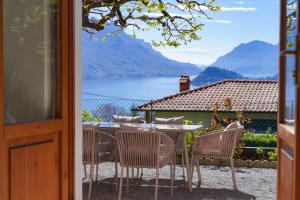a table and chairs with a view of a lake at Villa Sanziana in Menaggio
