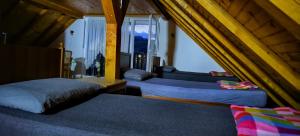 a bedroom with two beds and a large window at Villa sul lago in Jajce