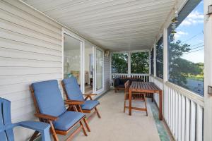 a porch with two chairs and a table at Lighthouse Overlook in Birch Town +28 photos