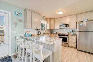 a kitchen with a large island with white appliances at Lighthouse Pointe in Birch Town