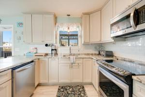 a white kitchen with white cabinets and a window at Lighthouse Pointe in Birch Town