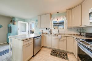 a kitchen with white cabinets and a counter top at Lighthouse Pointe in Birch Town +29 photos