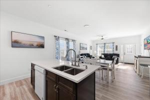 a kitchen and living room with a sink and a table at Lily Pad 2 in Birch Town