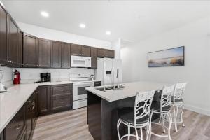 a kitchen with white appliances and wooden cabinets at Lily Pad 2 in Birch Town