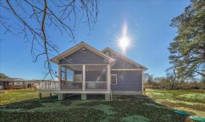 a tiny house with a porch in a yard at Lily Pad 2 in Birch Town