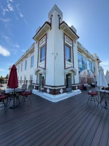a building with tables and chairs on a wooden deck at The Peak at Centralia Square - Self Check-In Hotel in Centralia